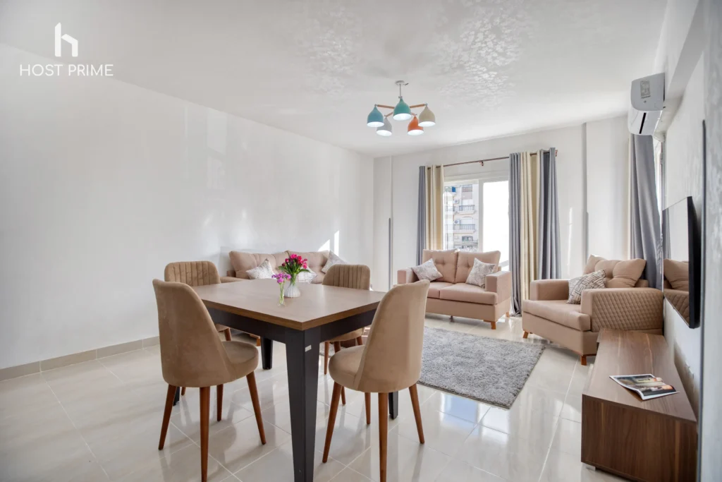 A cozy bedroom with a queen-sized bed, a nightstand, and a lamp in a Host Prime accommodation in New Cairo