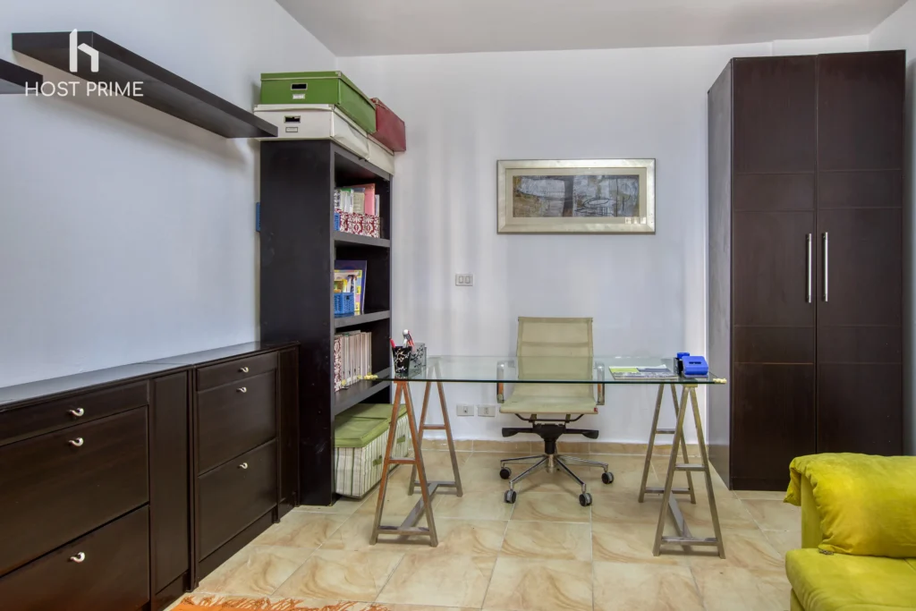 A balcony with a view of the city and a table with chairs in a comfy 2-bedroom apartment in Cairo