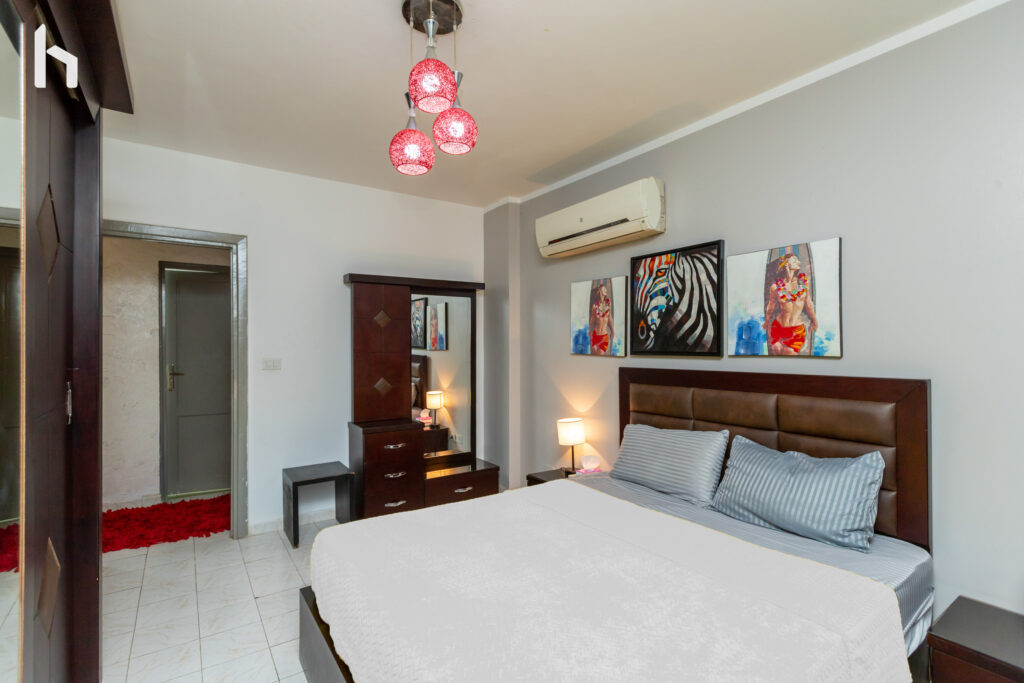Master bedroom with ample closet space in your Central Apartment, Al Rehab City.