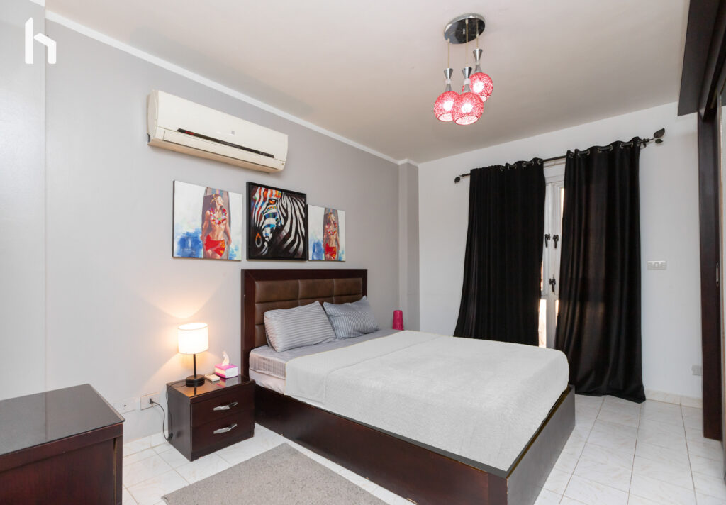 Master bedroom with ample closet space in your Central Apartment, Al Rehab City.