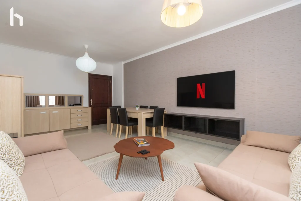 Bright and airy living room in spacious Al Rehab City apartment.