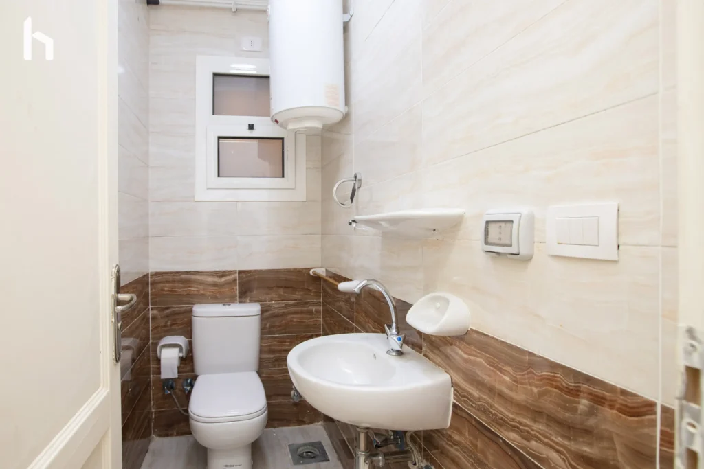 Modern bathroom with sleek finishes in your Al Rehab City serviced apartment.