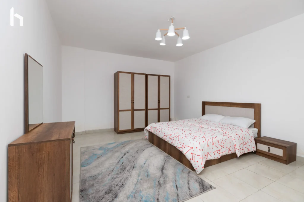 Inviting guest bedroom in spacious Al Rehab City serviced apartment.