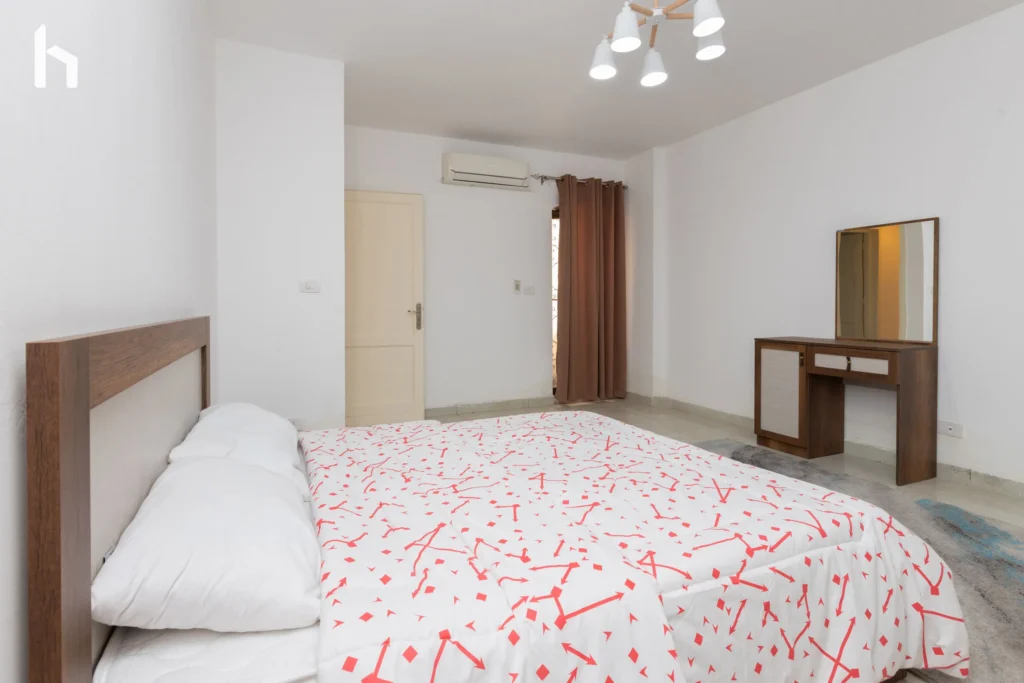 Inviting guest bedroom in spacious Al Rehab City serviced apartment.