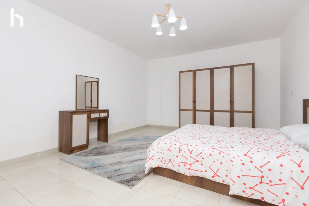 Inviting guest bedroom in spacious Al Rehab City serviced apartment.