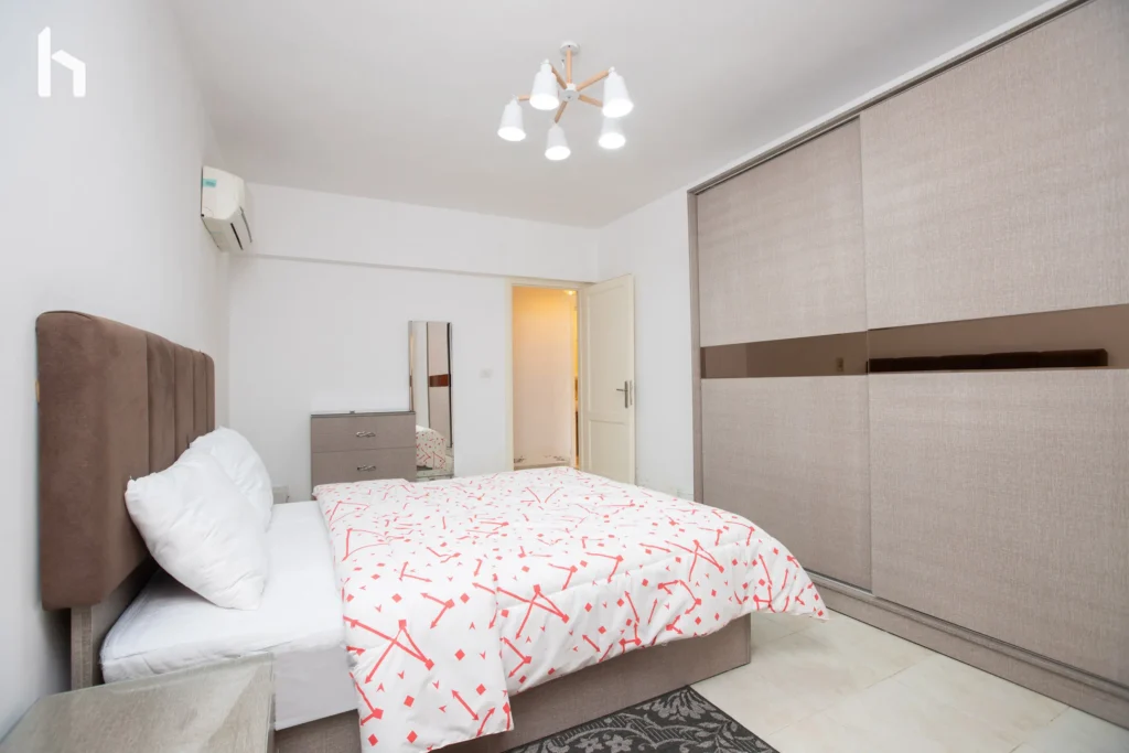 Master bedroom with ample closet space in your Al Rehab City 3BR apartment.