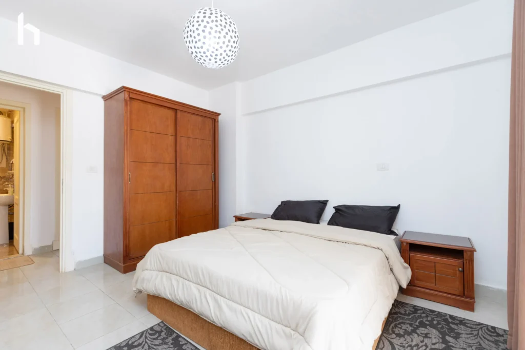 Spacious bedroom with generous closet space in your 3-bedroom apartment in Al Rehab City, Cairo, Egypt.